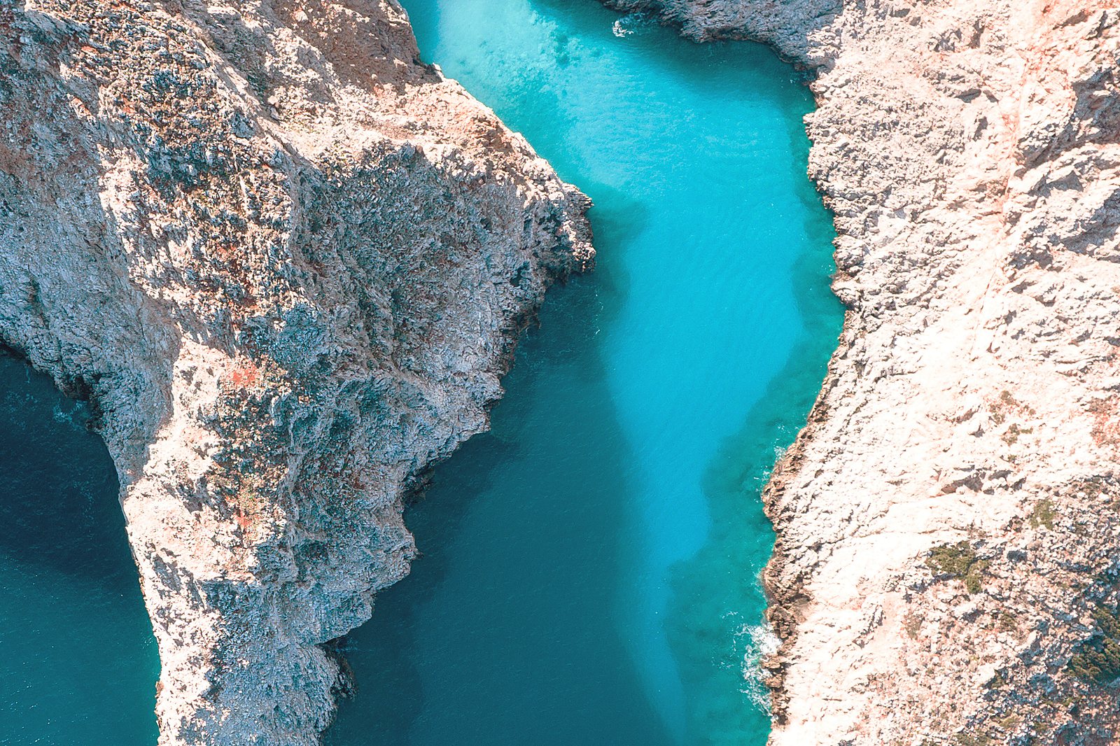 The narrow turquoise inlet of Seitan Limania, enclosed by steep cliffs on the Akrotiri peninsula